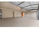 A well-lit garage featuring an epoxy floor and an orange door to the interior at 2620 E Harmon Ave, Las Vegas, NV 89121
