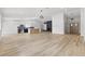 Open-concept living room featuring wood floors, a modern fireplace, and plenty of natural light at 2620 E Harmon Ave, Las Vegas, NV 89121