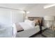Bedroom features a comfy bed, mirrored nightstand and sliding door to a balcony at 2650 Skylark Trail St, Henderson, NV 89044