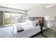 Bedroom features a comfy bed, mirrored nightstand and sliding door to a balcony at 2650 Skylark Trail St, Henderson, NV 89044