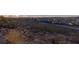 Expansive city view at twilight over a hillside with natural desert vegetation and homes below at 2650 Skylark Trail St, Henderson, NV 89044