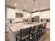 Bright kitchen with white cabinets, quartz countertops, stainless steel appliances and an island with seating at 2650 Skylark Trail St, Henderson, NV 89044
