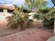 Backyard with palm trees and brick pavers, creating a simple outdoor space at 2679 Magic Moon Ln, Las Vegas, NV 89146