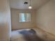 Simple bedroom with a window, basic lighting, and neutral walls at 2679 Magic Moon Ln, Las Vegas, NV 89146