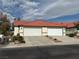 Charming single-story home featuring a red tile roof and attached two-car garage at 2679 Magic Moon Ln, Las Vegas, NV 89146