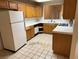 Spacious kitchen featuring light wood cabinets, basic appliances, and tile countertops at 2679 Magic Moon Ln, Las Vegas, NV 89146