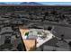 Home with desert landscaping, fenced yard, and small area of grass in an aerial view at 2721 Bruce Cir, North Las Vegas, NV 89030