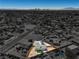 Aerial of home with privacy fence, artificial turf, and Las Vegas skyline in the background at 2721 Bruce Cir, North Las Vegas, NV 89030
