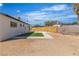 Landscaped backyard with privacy fence and small patch of artificial turf for low maintenance at 2721 Bruce Cir, North Las Vegas, NV 89030