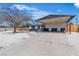 Cozy home featuring a covered carport, xeriscaped yard, mature trees, and updated exterior at 2721 Bruce Cir, North Las Vegas, NV 89030
