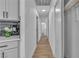 Hallway with wood floors, closet, white walls, and modern lighting, provides access to other rooms in the house at 2721 Bruce Cir, North Las Vegas, NV 89030