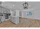This spacious kitchen opens to living area and features stainless appliances, quartz countertops and modern pendant lighting at 2721 Bruce Cir, North Las Vegas, NV 89030