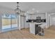 Updated kitchen with stainless steel appliances, island seating, and sliding doors providing natural light at 2721 Bruce Cir, North Las Vegas, NV 89030