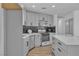 Bright kitchen features modern gray cabinetry, black backsplash, stainless appliances and a large quartz island at 2721 Bruce Cir, North Las Vegas, NV 89030