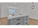 Kitchen island offers modern seating, storage space, and quartz countertops with stylish pendant lighting at 2721 Bruce Cir, North Las Vegas, NV 89030