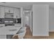 Bright kitchen features modern white cabinetry, black backsplash, stainless appliances and a large quartz island at 2721 Bruce Cir, North Las Vegas, NV 89030