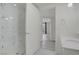 Bright bathroom featuring a glass-enclosed shower, white cabinets and sink with doorway to additional rooms at 29 Montelago Blvd # 213, Henderson, NV 89011