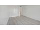 Bedroom with wood-style flooring, white walls, and a view into a bathroom at 29 Montelago Blvd # 213, Henderson, NV 89011