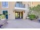 Inviting building entrance with glass doors, benches, and decorative planters at 29 Montelago Blvd # 213, Henderson, NV 89011
