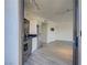 Modern kitchen with stainless steel appliances flowing into an open living space with light wood floors at 29 Montelago Blvd # 213, Henderson, NV 89011