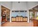 Home bar with wooden cabinets, dark countertops, and a sink for entertaining at 3151 Coachlight Cir, Las Vegas, NV 89117