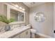 Bathroom showcases a marble countertop, decorative mirrors, and a modern vanity with a unique round mirror at 3151 Coachlight Cir, Las Vegas, NV 89117