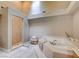 Luxurious bathroom featuring a soaking tub, walk-in shower, and plenty of natural light at 3151 Coachlight Cir, Las Vegas, NV 89117