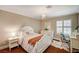 Bright bedroom featuring a desk, hardwood floors, and a chandelier at 3151 Coachlight Cir, Las Vegas, NV 89117