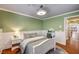 Bedroom showcases fresh green walls, a cozy bed, and an adjacent doorway leading to the house interior at 3151 Coachlight Cir, Las Vegas, NV 89117