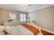 Bright bedroom features a chandelier, shuttered window, and a cozy bed with an orange throw blanket at 3151 Coachlight Cir, Las Vegas, NV 89117