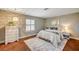 Bedroom with a decorative chest, area rug, shuttered window, and a comfortable bed with bedside table at 3151 Coachlight Cir, Las Vegas, NV 89117