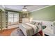 Charming bedroom features built-in shelving, a window seat, and a cozy bed with green accent pillows at 3151 Coachlight Cir, Las Vegas, NV 89117