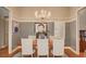 Elegant dining room featuring wood floors, a chandelier, and seating for six at 3151 Coachlight Cir, Las Vegas, NV 89117