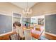 Formal dining area with chandelier and views to the kitchen and living room at 3151 Coachlight Cir, Las Vegas, NV 89117
