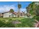Beautiful backyard featuring a pool, tall palm trees, and manicured landscaping at 3151 Coachlight Cir, Las Vegas, NV 89117