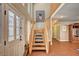 Bright entry foyer with wood floors, staircase, and large windows allowing natural light to flood the space at 3151 Coachlight Cir, Las Vegas, NV 89117