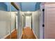Hallway with mirrored closet doors and hardwood floors at 3151 Coachlight Cir, Las Vegas, NV 89117