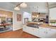 Open kitchen with a gas range, granite countertops, and views to dining and living room at 3151 Coachlight Cir, Las Vegas, NV 89117