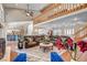 Open-concept living area featuring vaulted ceilings, wooden beams, a large leather sofa and elegant decor at 3151 Coachlight Cir, Las Vegas, NV 89117
