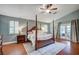 Spacious main bedroom with wood floors, a four-poster bed, and French doors to the outside at 3151 Coachlight Cir, Las Vegas, NV 89117