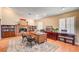 Large home office featuring a brick fireplace, custom wood desk, hardwood floors, and built-in bookshelves at 3151 Coachlight Cir, Las Vegas, NV 89117