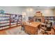 Comfortable home office with built-in bookshelves, a brick fireplace, hardwood floors, and plenty of workspace at 3151 Coachlight Cir, Las Vegas, NV 89117