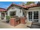 Well-designed outdoor kitchen with tile roof accents and a stainless steel grill at 3151 Coachlight Cir, Las Vegas, NV 89117