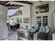 Covered patio with comfortable seating, ceiling fans, and views of the surrounding landscape at 3151 Coachlight Cir, Las Vegas, NV 89117