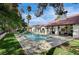 Gorgeous backyard pool with lush lawn and covered seating, perfect for relaxation and outdoor entertaining at 3151 Coachlight Cir, Las Vegas, NV 89117