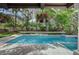 Inviting pool area with hanging floral baskets and meticulously landscaped surroundings at 3151 Coachlight Cir, Las Vegas, NV 89117