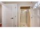 Modern shower stall is surrounded by white doors and beige tile with a golden frame at 3151 Coachlight Cir, Las Vegas, NV 89117