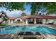 This backyard features a large, sparkling pool and spa, surrounded by ample patio space at 3151 Coachlight Cir, Las Vegas, NV 89117