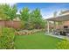 Lush backyard with a well-maintained lawn and thoughtfully designed landscaping at 3171 Biccari Ave, Henderson, NV 89044