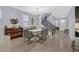 Elegant dining room with stylish lighting, seating for six, and staircase access to upper level at 3171 Biccari Ave, Henderson, NV 89044